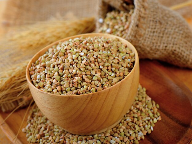 Buckwheat in wood scoop on table