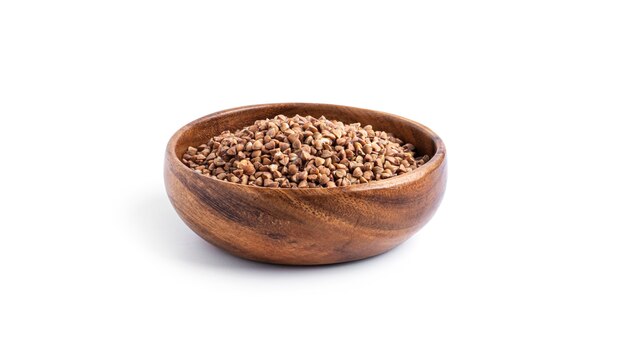 Buckwheat in a wooden bowl isolated on a white background. High quality photo