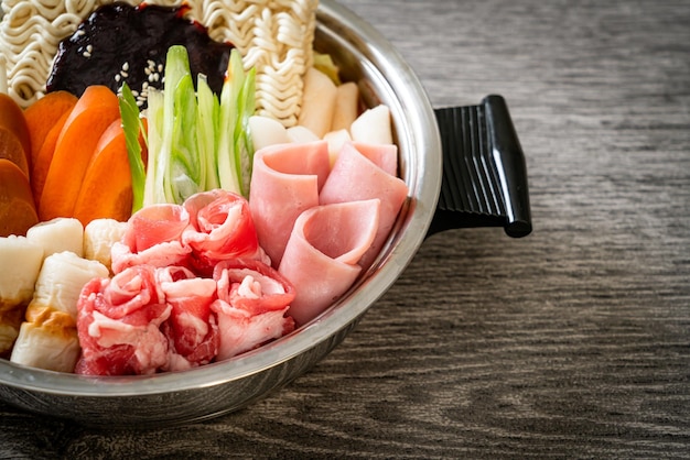 Budae Jjigae or Budaejjigae (Army stew or Army base stew). It is loaded with Kimchi, spam, sausages, ramen noodles and much more - popular Korean hot pot food style