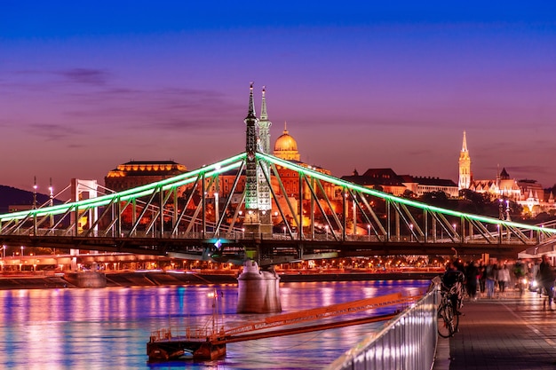 Budapest at night, freedom bridge on the danube river, reflection of night lights on the water