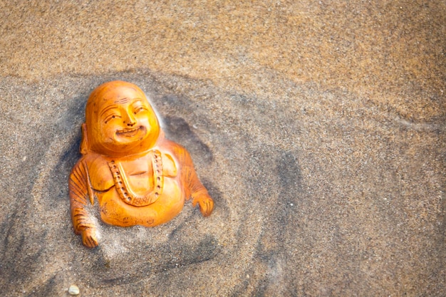 Budda statuette on the beach