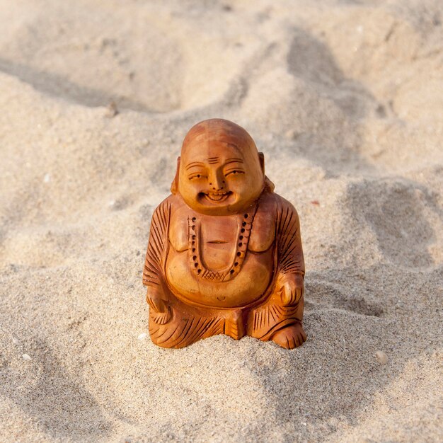 Budda statuette on the beach