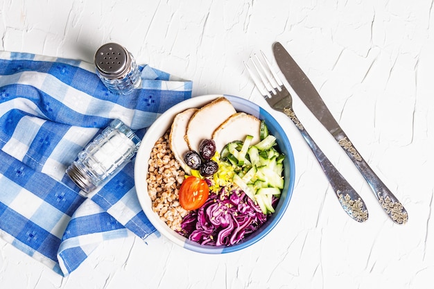 Buddha Bowl. Buckwheat, baked lean pork, red cabbage, cucumber, tomato, olives, flax seeds.