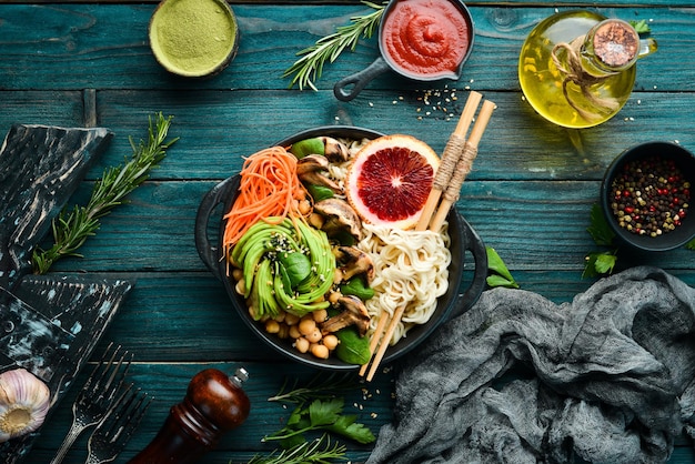 Buddha bowl Noodles chickpeas avocados and mushrooms Healthy food Top view Free space for your text