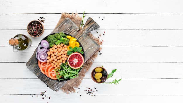 Buddha bowl. Turkish peas, broccoli, tomatoes, onions. Top view. Free space for your text.