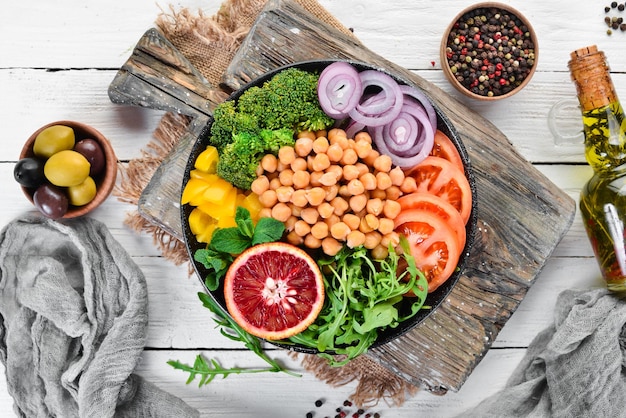 Buddha bowl. Turkish peas, broccoli, tomatoes, onions. Top view. Free space for your text.