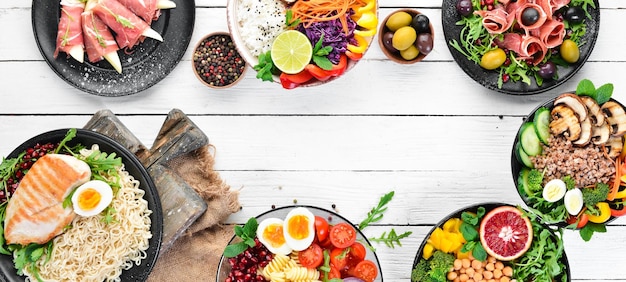 Buddha bowl on a white wooden background Assortment of healthy food Top view Free space for your text