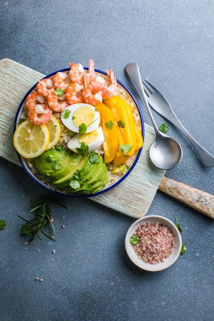 Buddha bowl with avocado prawns rice on light background Healthy food clean eating Buddha bowl top view