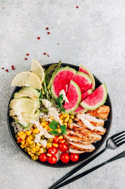 Buddha bowl with brown rice, grilled chicken breast, and vegetables