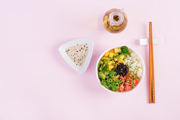 Buddha bowl with rice, mango, avocado and salmon