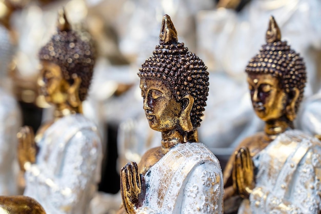 Buddha statue figures souvenir on display for sale on street market in Ubud Bali Indonesia Handicrafts and souvenir shop display close up