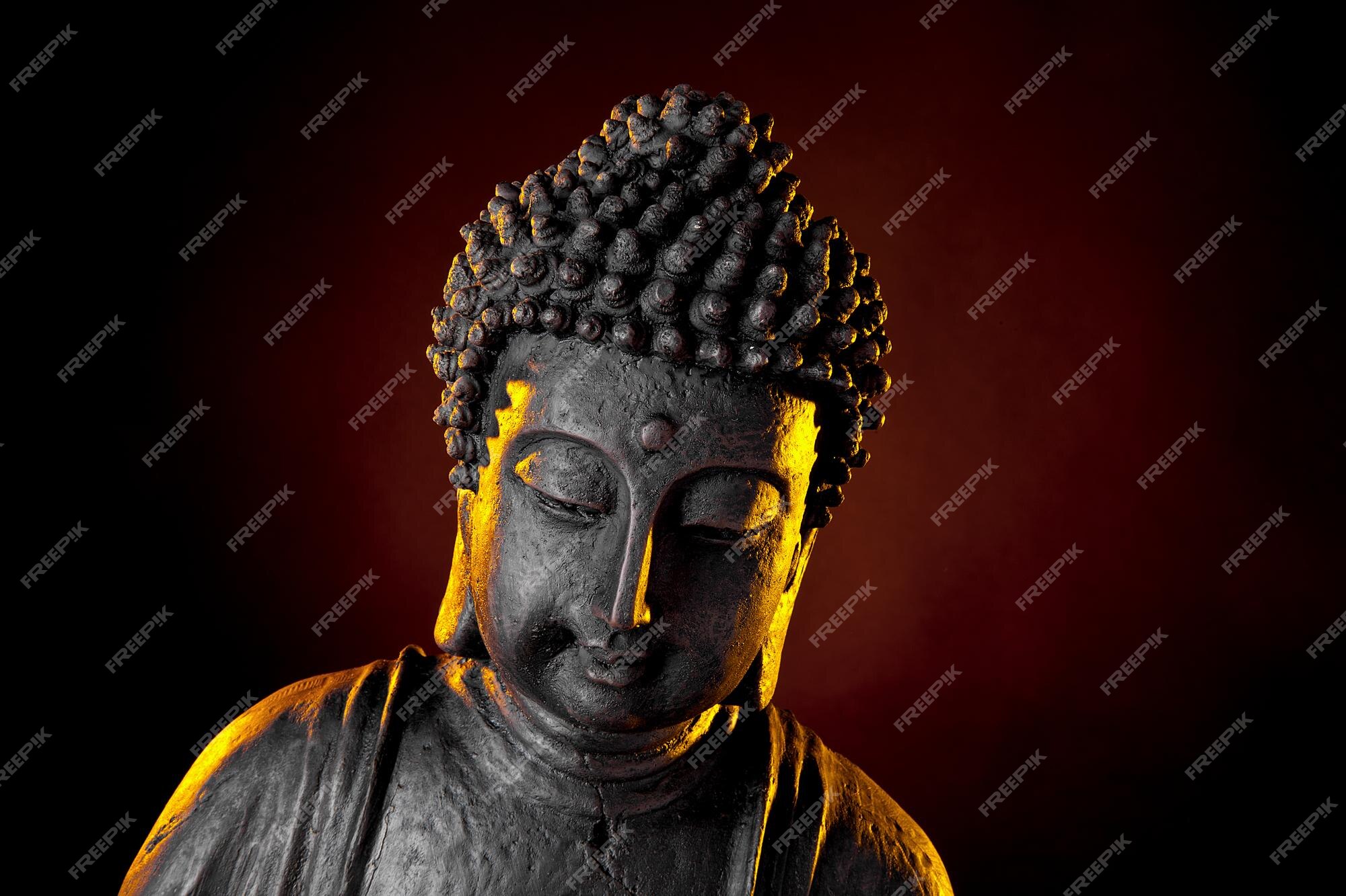 Premium Photo | Buddha statue with glow against black background Premium Photo | Buddha statue with glow against black background