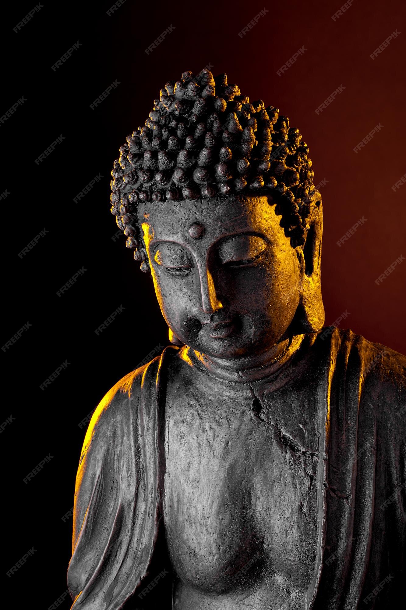 Premium Photo | Buddha statue with glow against black background Premium Photo | Buddha statue with glow against black background