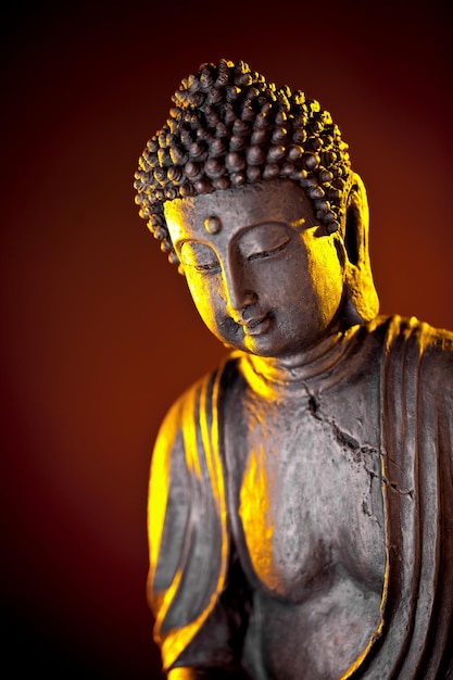 Buddha statue with glow against black background