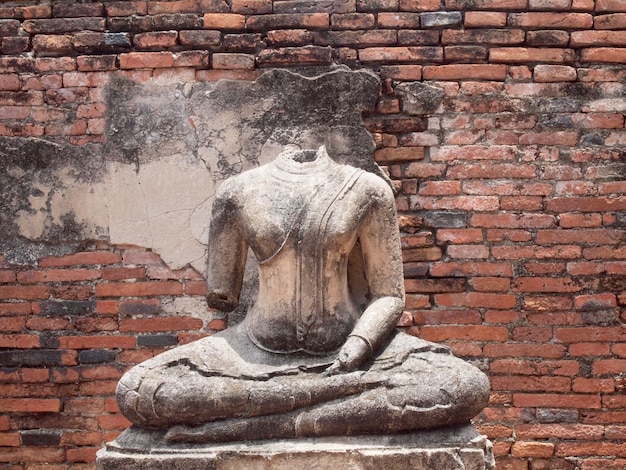 Buddha with old brick wall Ayutthaya, Thailand