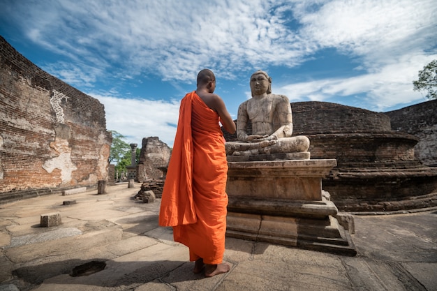 Buddhist monk at historical Polonnaruwa Vatadage in Polonnaruwa, Sri Lanka