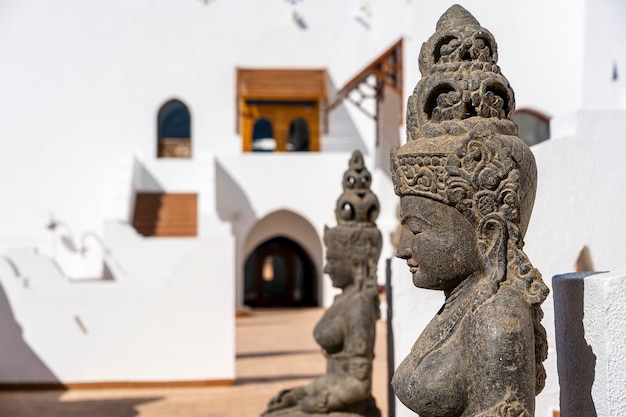 Buddhist statues in front of the hotel entrance for good luck and attraction of tourists to the resort town of Sharm El Sheikh, Egypt, close up