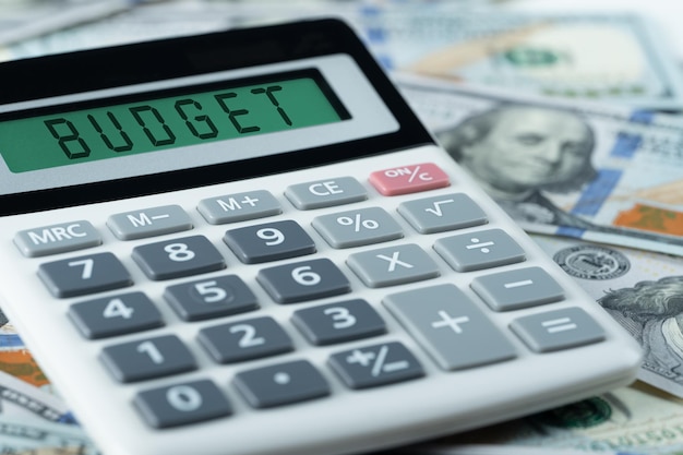 Budget calculator calculating annual or monthly expenses managing budget budget text on calculator on us dollars background financial budget