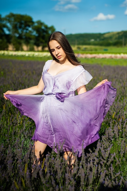 Bueautiful young woman on the summer field