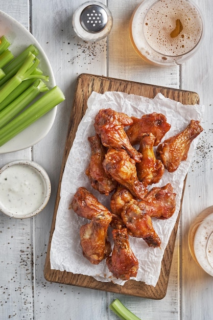 Buffalo chicken wings with celery and beer