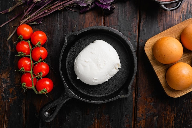 Buffalo mozzarella set, on old dark  wooden table background, top view flat lay