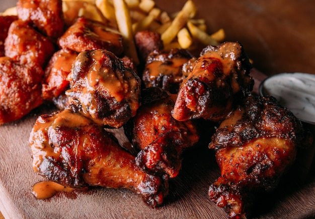 Buffalo Wing and fries in wood table to