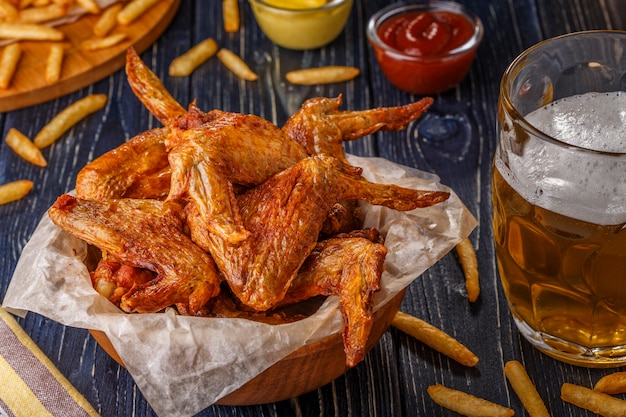 Buffalo wings with french fries and beer