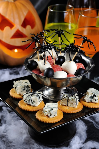 Buffet snack of cracker with blue cheese and bowl salami mozzarella olives on the table  Halloween