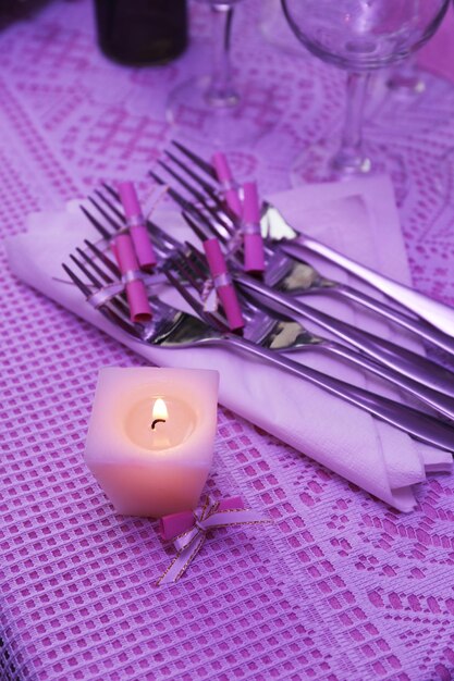 Buffet table with dishware and candle waiting for guests