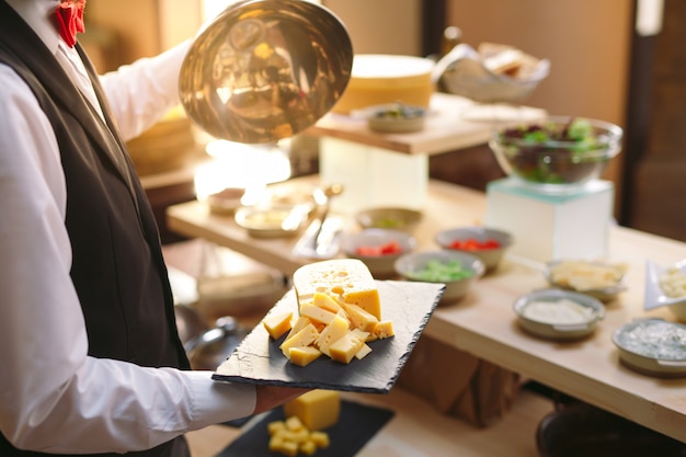 Buffet. The waiter sets the table.