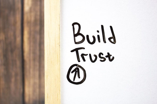 Photo build trust concept text on a white board written in black marker