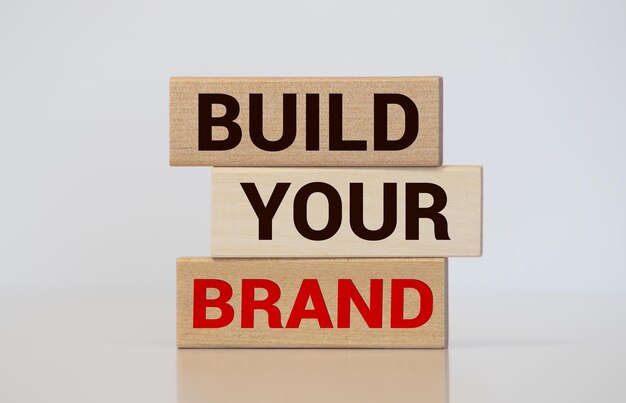 Photo build your brand written on wooden blocks with vintage styled background