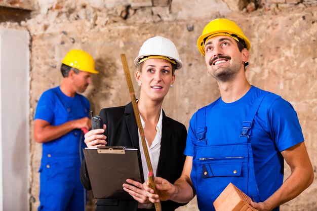 Builder and architect discussing on construction site