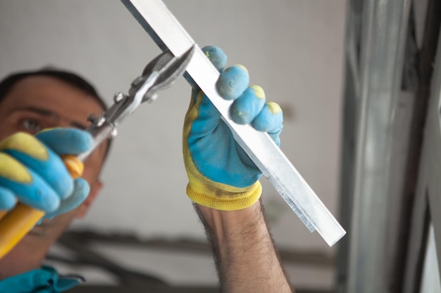 Builder cuts profile with scissors