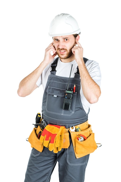 A builder or an employee in a protective helmet is listening Isolated over white background