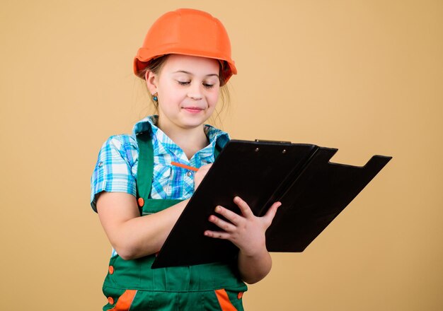 builder engineer architect kid worker in hard hat child care development small girl repairing in workshop foreman inspector repair safety expert future profession confident worker