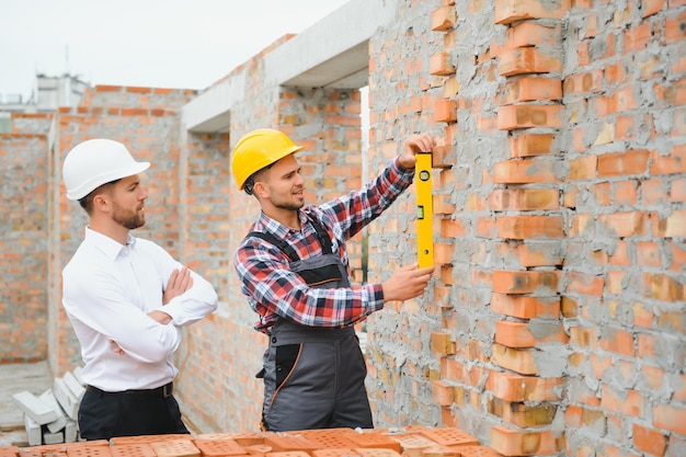 Builder and engineer on construction site