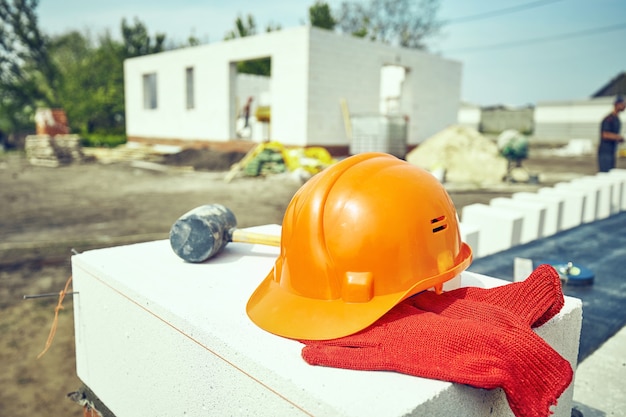 Builder lays aerated concrete block at a construction site