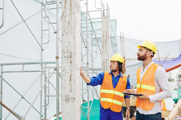 Builder showing drived in piles