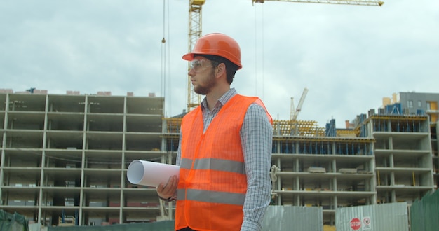 Builder standing in front of building under construction