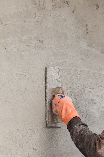 Builder worker plastering concrete