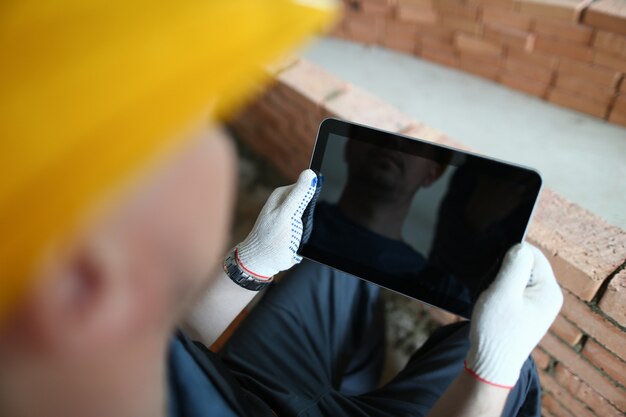 Builder in yellow helmet