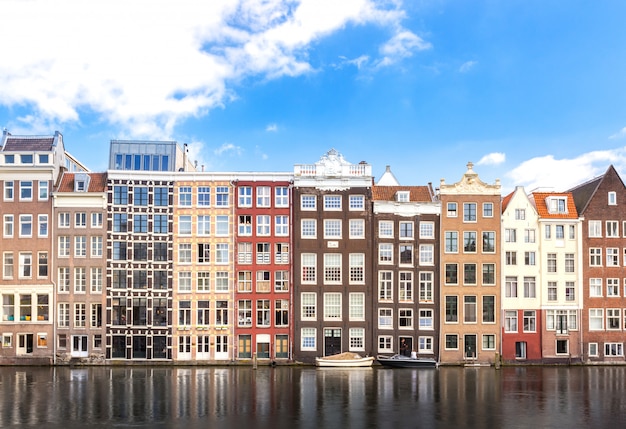 Building of apartment along river, cruise or ship transportation in Amsterdam in Netherlands