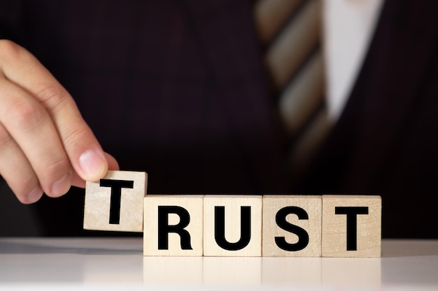 Photo building blocks in hands spelling out trust