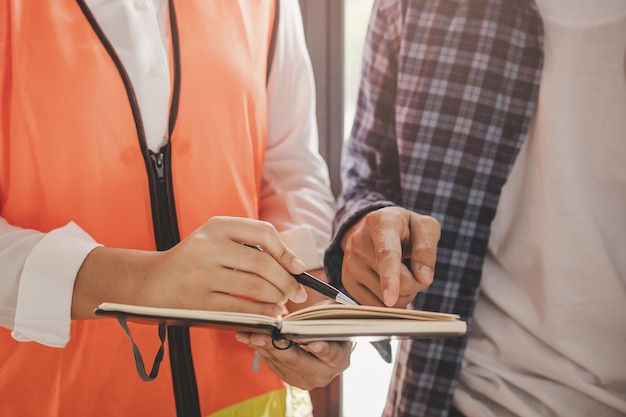 Photo building, builders asian young contractor man, woman inspecting reconstructed construction, renovation check defect, inspection at job site, home or apartment. worker, coworker working in workplace.