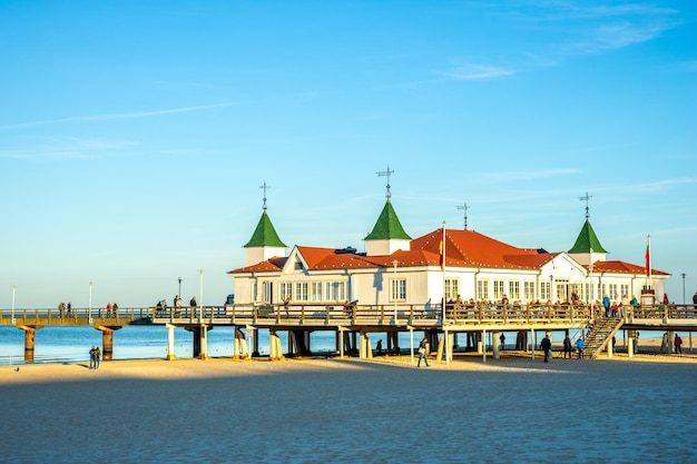 Building by sea against blue sky