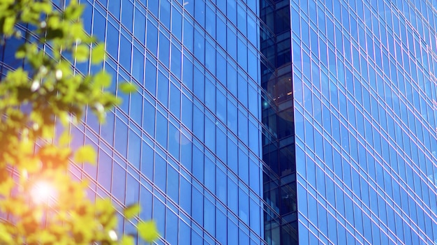 A building in the city is reflected in the glass of the building