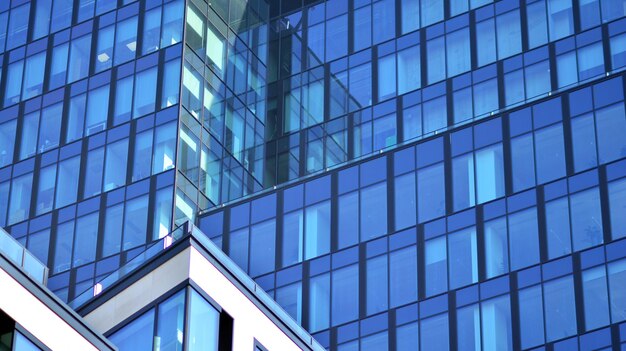 a building in the city of london has a blue glass facade.