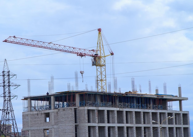 Building under construction against crane
