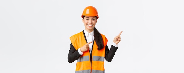 Building construction and industrial concept smiling female asian engineer in safety helmet and refl